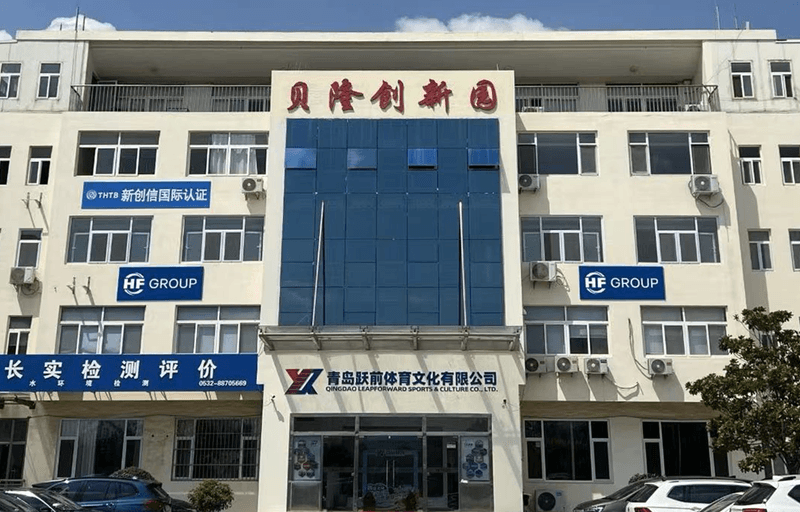 Front view of the HF GROUP office building in Qingdao, China, with a blue glass facade in the center and Chinese lettering at the top.