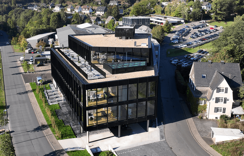 Aerial view of the modern office building of the HF GROUP in Freudenberg, Germany