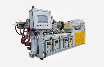 Strainer-Extruder with large control panel, pipe assembly, yellow guards, and cabling.