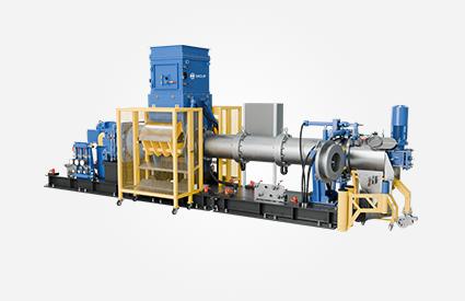 Long single-screw extruder with large cylindrical housing, yellow safety guards, and blue units.