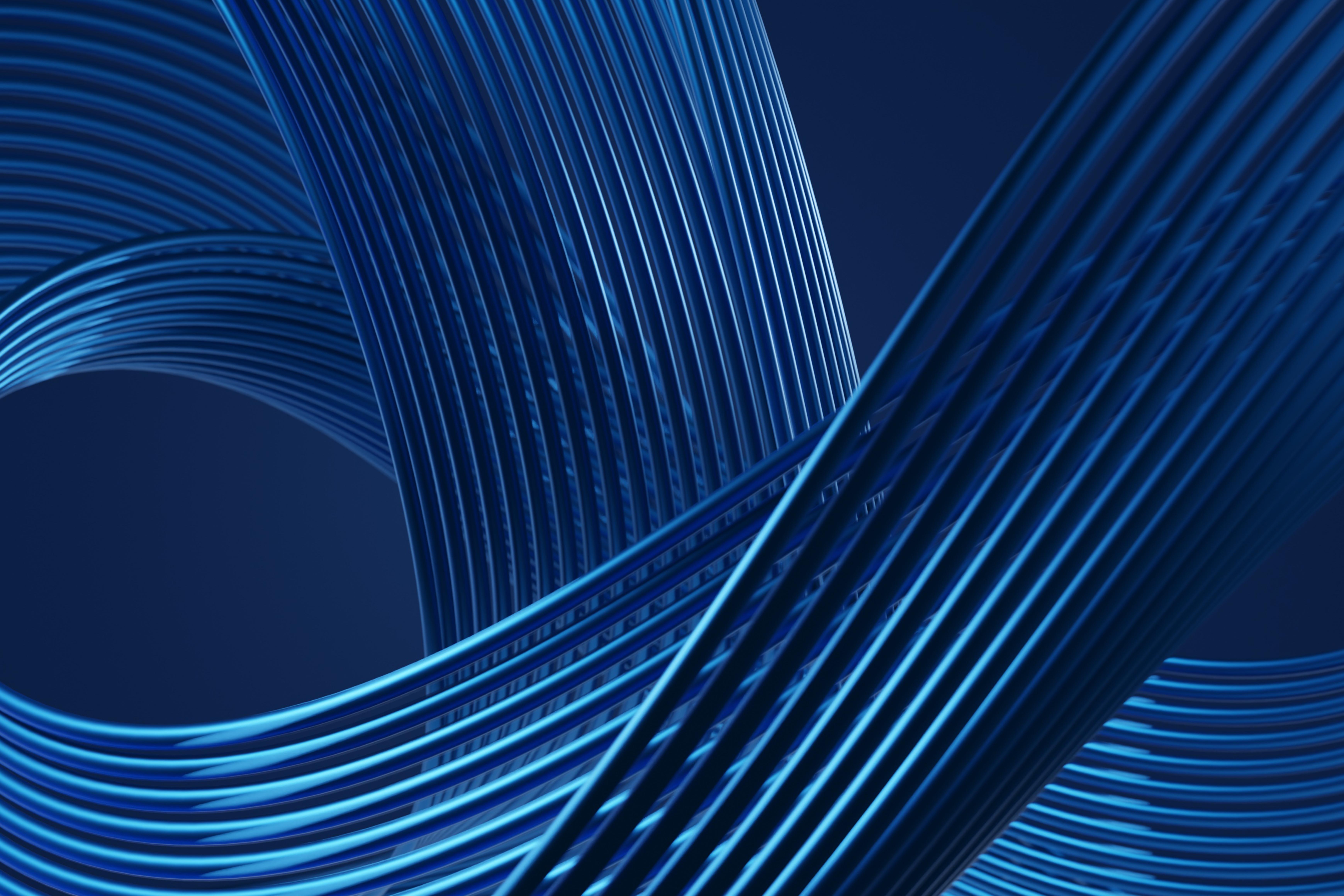 Abstract image of curved, intertwined blue lines forming smooth, wave-like shapes against a dark blue background.