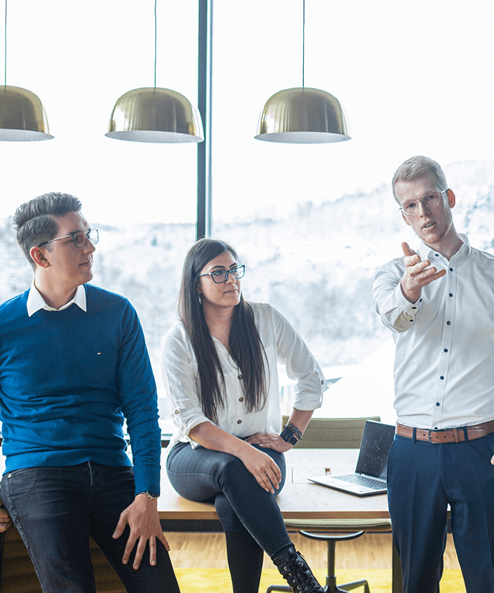 Two men and a woman are discussing in the office.
