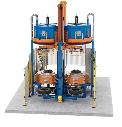 Large blue and orange tyre curing press with multiple round stations and frame.