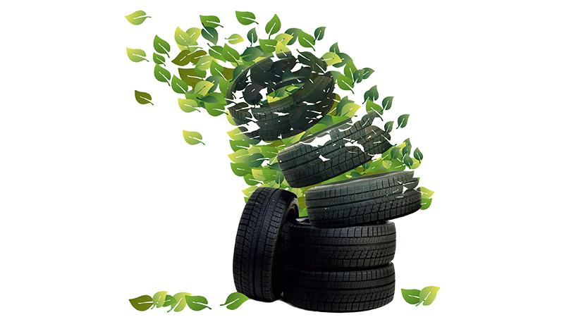 Stack of tyres dissolving into green leaves.