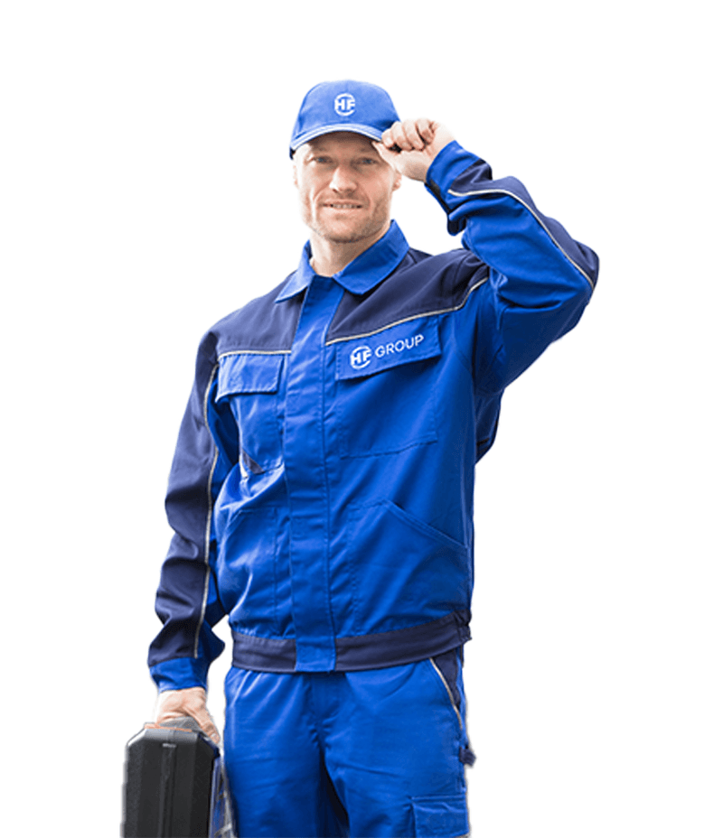 Person in blue work clothing holding a tool case.
